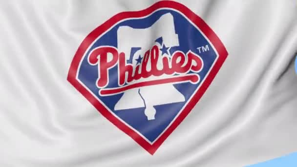 Gros plan du drapeau avec le logo de l'équipe de baseball Philadelphia Phillies MLB, boucle transparente, fond bleu. Animation éditoriale. 4K — Video
