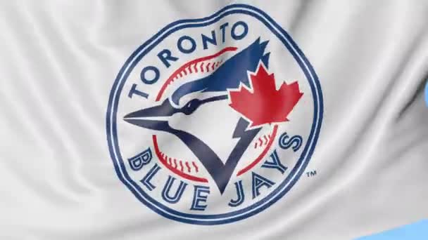 Primer plano de la bandera ondeante con el logotipo del equipo de béisbol Toronto Blue Jays MLB, lazo sin costuras, fondo azul. Animación editorial. 4K — Vídeos de Stock