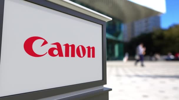 Σήμανση οδών σκάφους με Canon Inc. λογότυπο. Κέντρο θολή office και περπάτημα άτομα φόντο. Συντακτική 3d rendering 4k — Αρχείο Βίντεο