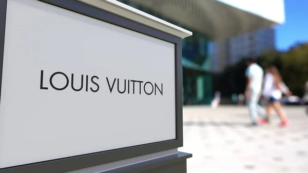 Placa de sinalização de rua com logotipo Louis Vuitton. Centro de escritórios desfocado e pessoas ambulantes fundo. Renderização 3D editorial — Fotografia de Stock