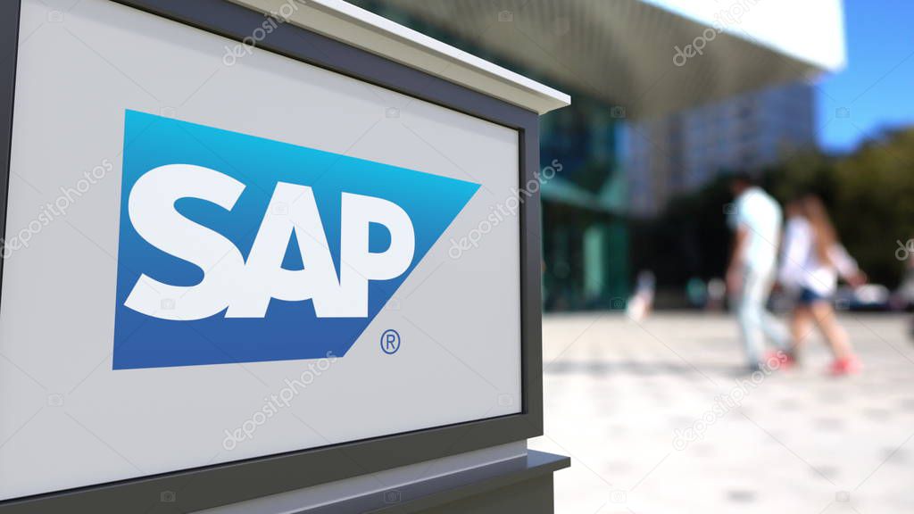Street signage board with SAP SE logo. Blurred office center and walking people background. Editorial 3D United States