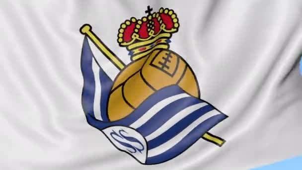 Close-up de acenando bandeira com logotipo do clube de futebol Real Sociedad, loop sem costura, fundo azul. Animação editorial. 4K — Vídeo de Stock