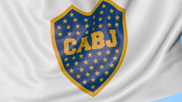 Nahaufnahme einer schwenkenden Fahne mit dem Logo des Fußballklubs der Boca Juniors, nahtloser Schlaufe, blauem Hintergrund. redaktionelle Animation. 4k — Stockvideo