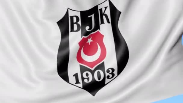 Primo piano della bandiera sventolante con il logo della squadra di calcio Besiktas, anello senza cuciture, sfondo blu. Animazione editoriale. 4K — Video Stock