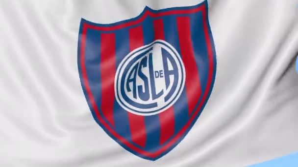 Primer plano de la bandera ondeante con el logotipo del club de fútbol San Lorenzo de Almagro, lazo sin costuras, fondo azul. Animación editorial. 4K — Vídeos de Stock