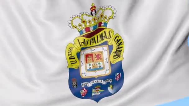 Close-up de acenando bandeira com logotipo do clube de futebol UD Las Palmas, loop sem costura, fundo azul. Animação editorial. 4K — Vídeo de Stock