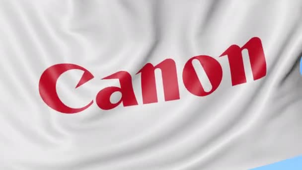 Primer plano de la bandera ondeando con el logotipo de Canon Inc., bucle sin costuras, fondo azul, animación editorial. 4K ProRes — Vídeo de stock