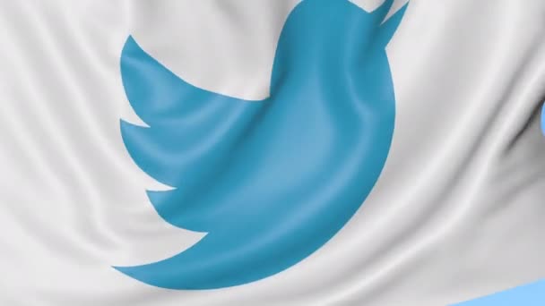 Крупный план размахивания флагом с логотипом Twitter, Inc., бесшовный цикл, синий фон, редакционная анимация. 4K ProRes — стоковое видео