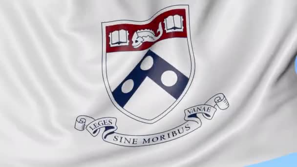 Close-up van de vlag met het embleem van de Universiteit van Pennsylvania, naadloze loops, blauwe achtergrond zwaaien. Redactionele animatie. 4k — Stockvideo