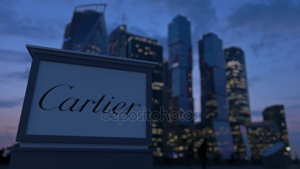 Street signage board with Cartier logo in the evening.  Blurred business district skyscrapers background. Editorial 3D rendering 4K — Stock Video