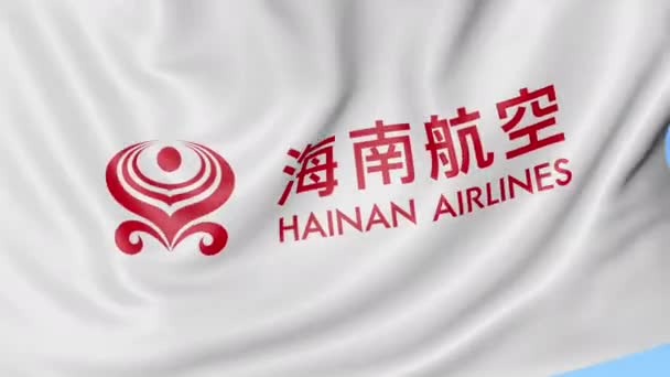 Waving flag of Hainan Airlines against blue sky background, seamless loop. Editorial 4K animation — Stock Video