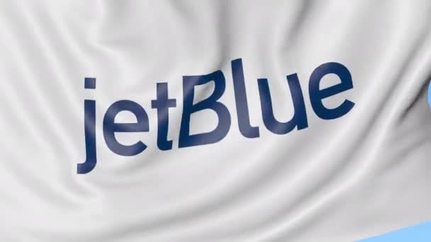 Drapeau agitant de JetBlue sur fond bleu ciel, boucle transparente. Éditorial animation 4K — Video