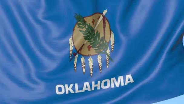 Wapperende vlag van Oklahoma state tegen blauwe hemel. Naadloze loops 4k clip — Stockvideo