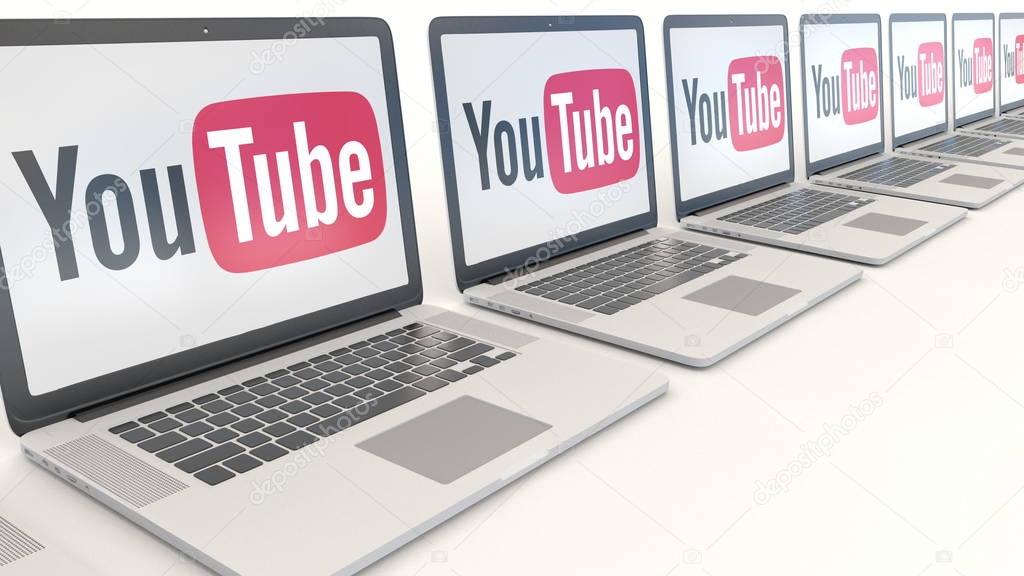 Modern laptops with YouTube logo. Computer technology conceptual editorial 3D