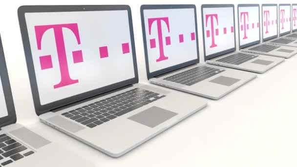 Modern laptops with T-Mobile logo. Computer technology conceptual editorial 4K clip, seamless loop — Stock Video