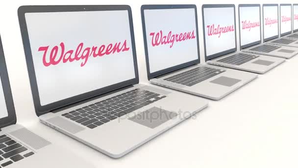 Portátiles modernos con logotipo de Walgreens. Tecnología informática editorial conceptual clip 4K, bucle sin costura — Vídeos de Stock