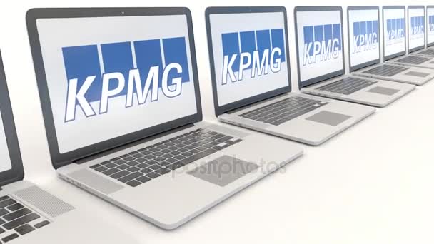 Moderne Laptops mit kpmg-Logo. Computertechnologie konzeptioneller redaktioneller 4k-Clip, nahtlose Schleife — Stockvideo