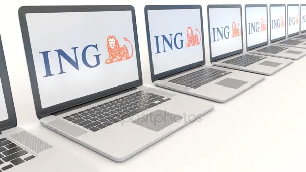 Современные ноутбуки с логотипом ING Group. Концептуальная редакционная работа по компьютерным технологиям 4К клип, бесшовный цикл — стоковое видео