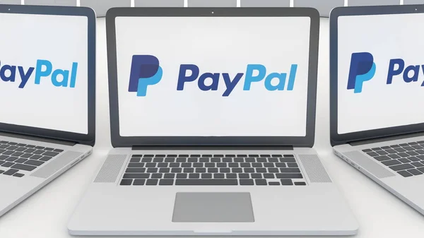 Portátiles con el logotipo de PayPal en la pantalla. Tecnología informática editorial conceptual 3D rendering — Foto de Stock