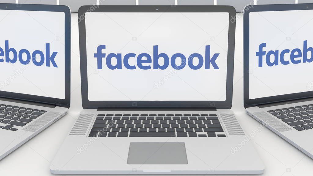 Laptops with Facebook logo on the screen. Computer technology conceptual editorial 3D