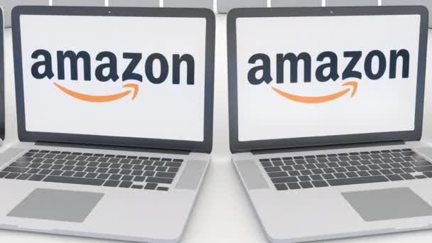 Laptops com logotipo Amazon.com na tela. Tecnologia de computador editorial conceitual clipe 4K, loop sem costura — Vídeo de Stock