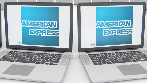 Bärbara datorer med American Express-logotypen på skärmen. Dator teknik konceptuella redaktionella 4k klipp, sömlös loop — Stockvideo
