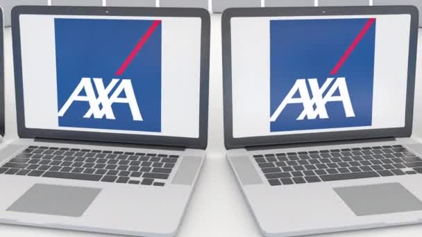 Ноутбуки с логотипом AXA на экране. Концептуальная редакционная работа по компьютерным технологиям 4К клип, бесшовный цикл — стоковое видео