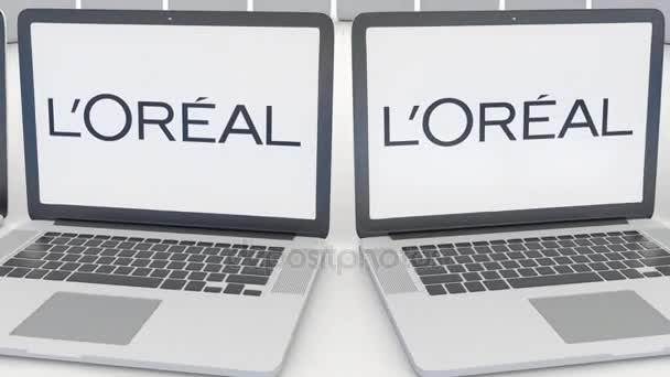 Laptops com logotipo LOreal na tela. Tecnologia de computador editorial conceitual clipe 4K, loop sem costura — Vídeo de Stock