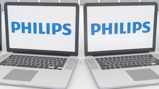Notebooky s logem Philips na obrazovce. Počítač technika koncepční redakční 4k klip, bezešvé smyčka — Stock video