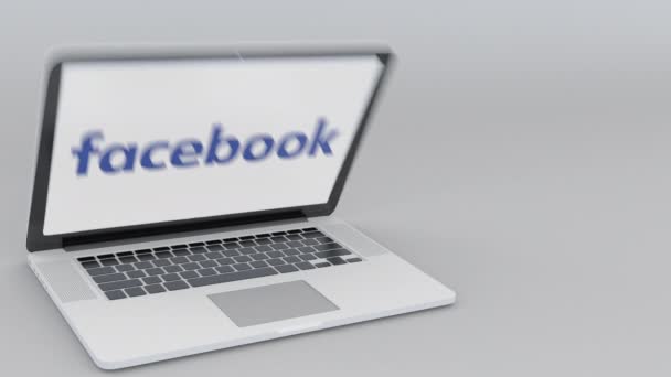 Laptop öffnen und schließen mit Facebook-Logo auf dem Bildschirm. Computertechnologie konzeptioneller redaktioneller 4k-Clip — Stockvideo