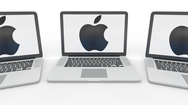 Notizbücher mit Apple inkl. Logo auf dem Bildschirm. Eingang zum modernen Bürogebäude. Computertechnologie konzeptionelles redaktionelles 3D-Rendering — Stockfoto