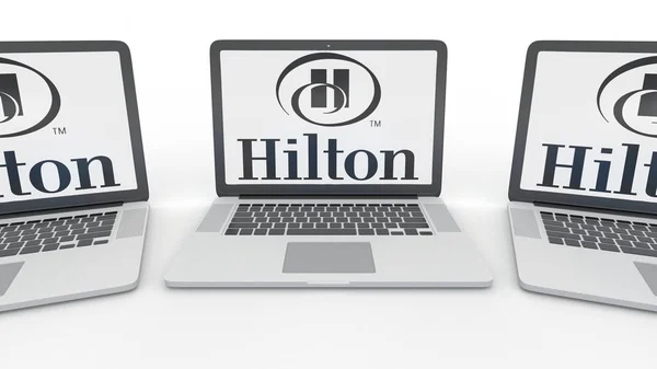 Notebooks with Hilton Hotels Resorts logo on the screen. Computer technology conceptual editorial 3D rendering — Stock Photo, Image