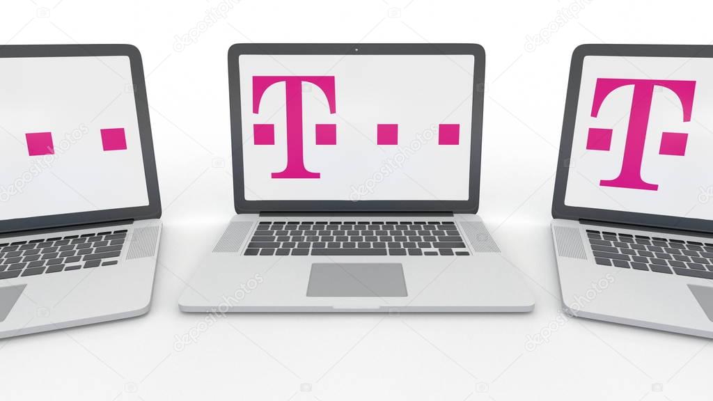 Notebooks with T-Mobile logo on the screen. Computer technology conceptual editorial 3D