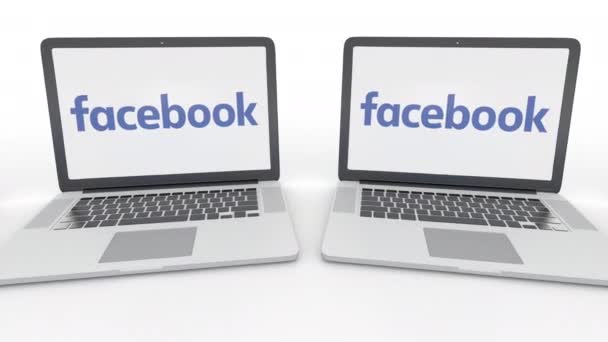 Laptops met Facebook logo op het scherm. Computer technologie conceptuele redactionele 4k clip, naadloze loops — Stockvideo