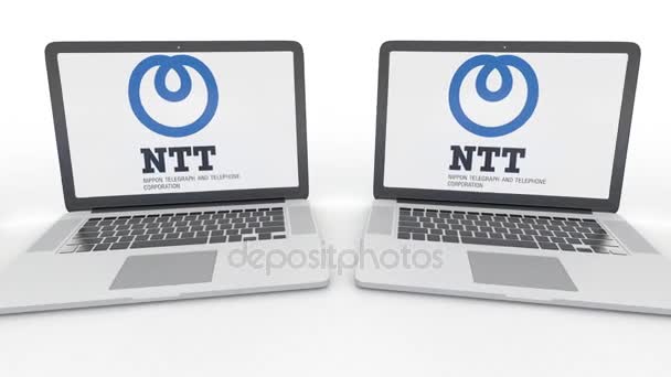 Notebooks with Nippon Telegraph and Telephone Corporation NTT logo on the screen. Computer technology conceptual editorial 4K clip, seamless loop — Stock Video