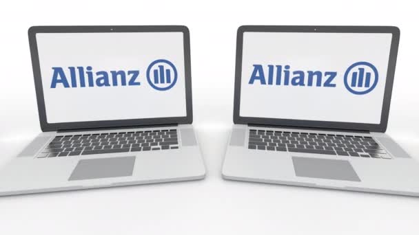 Allianz logo üstünde belgili tanımlık perde ile dizüstü bilgisayar. Bilgisayar teknolojisi kavramsal editoryal 4k klip, sorunsuz döngü — Stok video