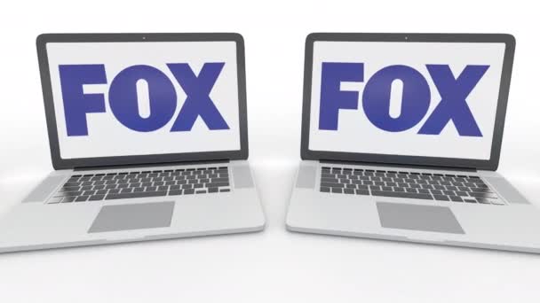 Cadernos com o logotipo da Fox Broadcasting Company na tela. Tecnologia de computador editorial conceitual clipe 4K, loop sem costura — Vídeo de Stock