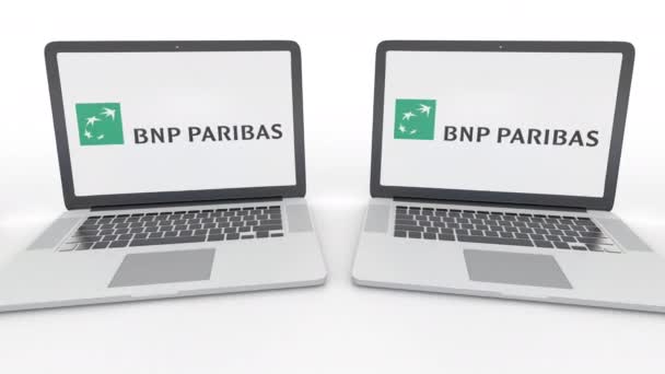 Cuadernos con logo BNP Paribas en la pantalla. Tecnología informática editorial conceptual clip 4K, bucle sin costura — Vídeos de Stock