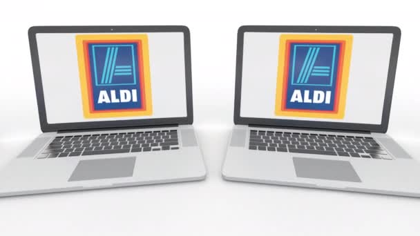 Anteckningsböcker med Aldi-logotypen på skärmen. Dator teknik konceptuella redaktionella 4k klipp, sömlös loop — Stockvideo