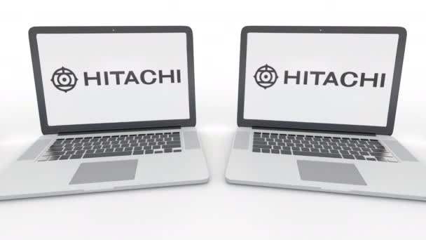 Cuadernos con el logotipo Hitachi en la pantalla. Tecnología informática editorial conceptual clip 4K, bucle sin costura — Vídeo de stock