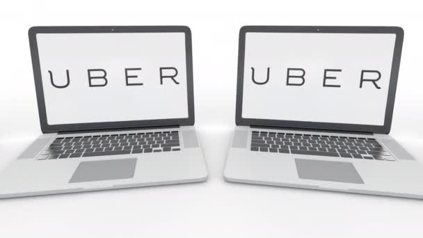 Notebooks with Uber Technologies Inc. logo on the screen. Computer technology conceptual editorial 4K clip, seamless loop — Stock Video