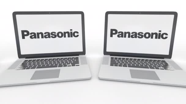 Panasonic Corporation logo üstünde belgili tanımlık perde ile dizüstü bilgisayar. Bilgisayar teknolojisi kavramsal editoryal 4k klip, sorunsuz döngü — Stok video