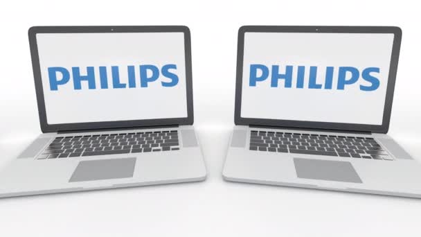 Notebooks com logotipo Philips na tela. Tecnologia de computador editorial conceitual clipe 4K, loop sem costura — Vídeo de Stock