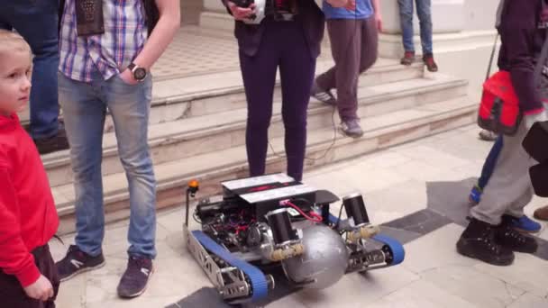 WARSAW, POLAND - MARCH, 4, 2017. Girl holding laptop and her DIY caterpillar robot. 4K video — Stock Video