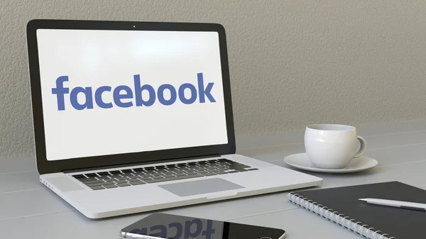 Portatile con logo Facebook sullo schermo. Moderno ambiente di lavoro concettuale editoriale rendering 3D — Foto Stock