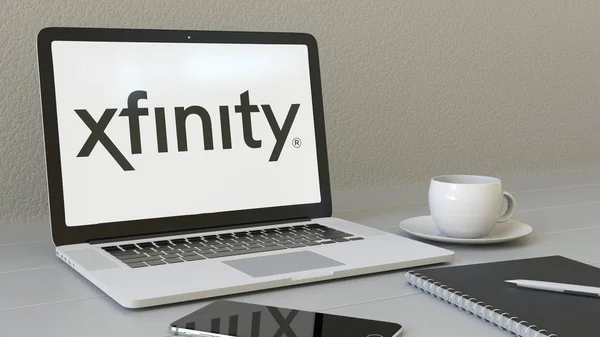 Portátil con el logotipo de Xfinity en la pantalla. Moderno lugar de trabajo editorial conceptual 3D rendering — Foto de Stock