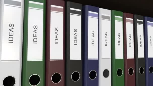 Line of multicolor office binders with Ideas tags. 4K seamless loop clip — Stock Video