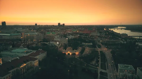 ヴィスワ川と夕方には、ポーランドのワルシャワの建物の空中ショットは。オレンジ色の夕焼け空 — ストック写真