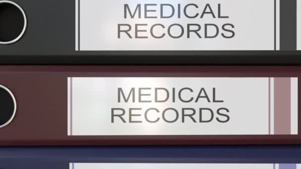 Vertical stack of multicolor office binders with Medical records tags — Stock Video