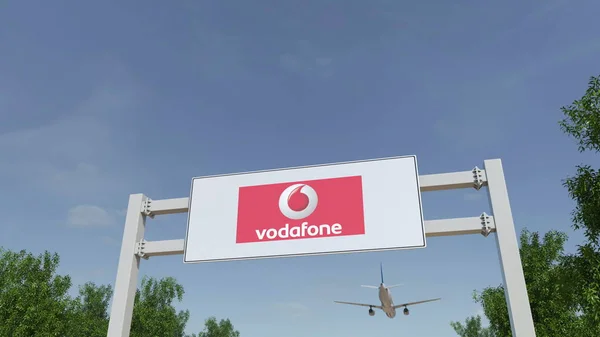 A repülőgép repül át reklám billboard Vodafone logo. Szerkesztői 3d-leképezés — Stock Fotó